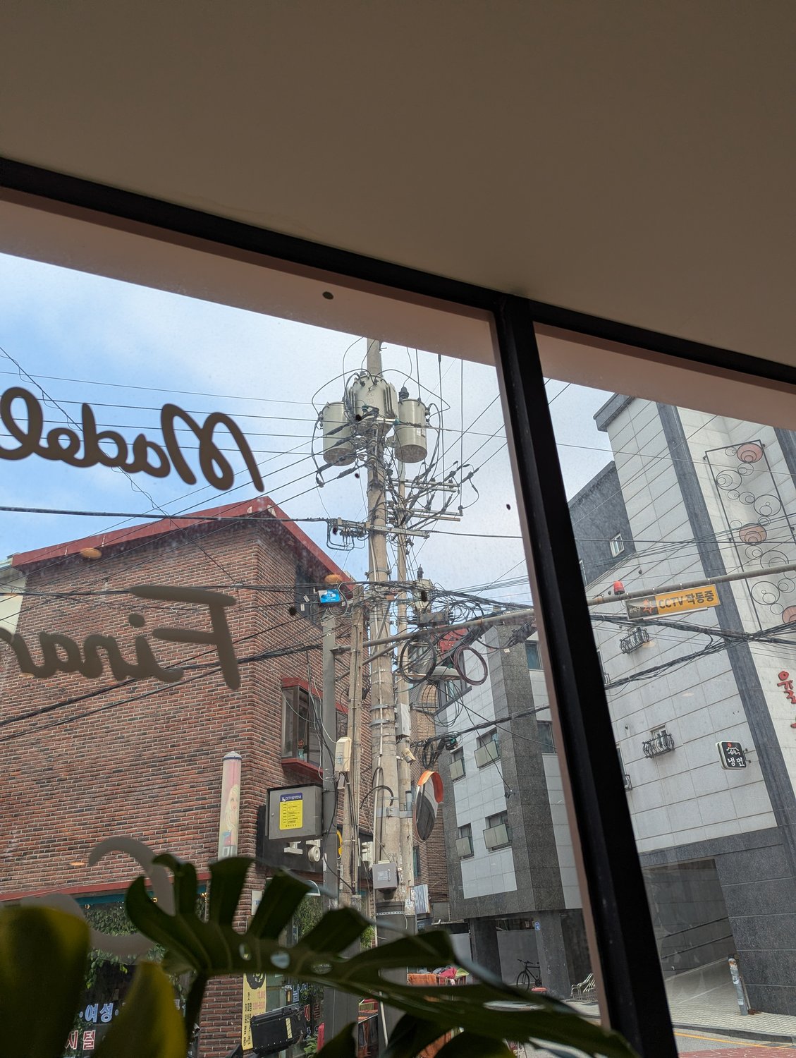 Strommast in Seoul mit mehreren Transformatoren und einem wilden Gewirr aus Strom- und Telefonkabeln